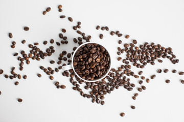 top view of white cup with scattered coffee beans, isolated on white