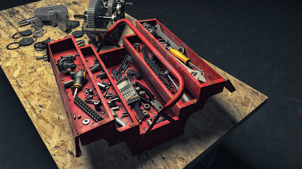 Werkzeugkiste auf einer Werkbank vor zerlegtem Getriebe