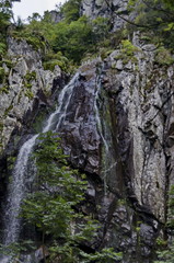 Upper and middle part of fresh Boyana waterfalls in deep forest and rock, Vitosha, Bulgaria