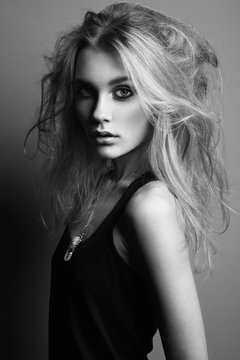 Portrait of young beautiful girl with blonde hair. Fashion photo Hairstyle. Make up. Vogue Style. Black and white photo