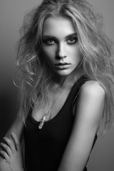 Portrait of young beautiful girl with blonde hair. Fashion photo Hairstyle. Make up. Vogue Style. Black and white photo