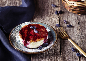Pieces of light dietary homemade semolina cake with honeysuckle sauce on a rustic vintage wooden...