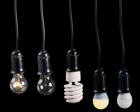 five electric lamps in receptacle on black