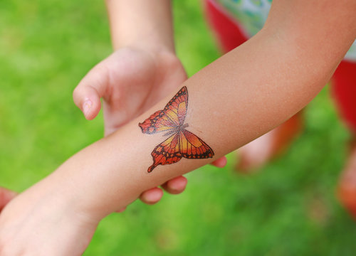 Butterfly Sticker on child hand, Dress up tattoos.