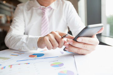 Young businessman working with mobile phone