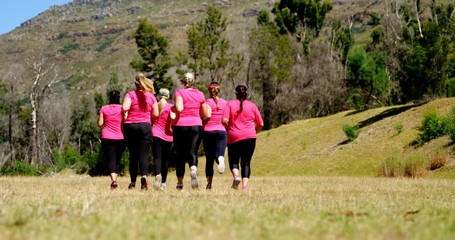Group of women running while training in the boot camp - Powered by Adobe