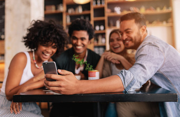 Group of friends making a self portrait with mobile phone