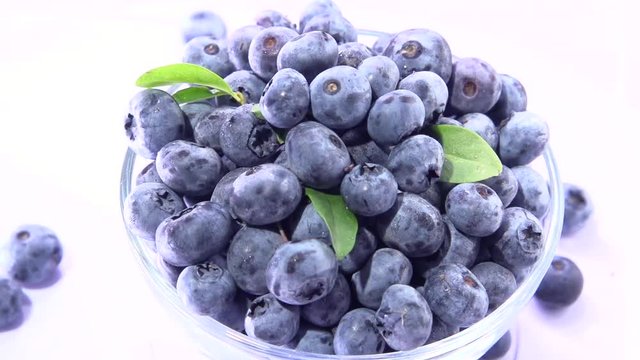 Berries blueberries. Blueberry berry is poured from a spoon. Slow motion 240 fps. High speed camera shot. Full HD 1080p. 