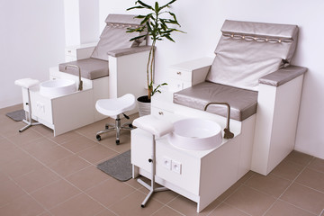 Interior of modern manicure salon without people. Luxury work places for masters of pedicure