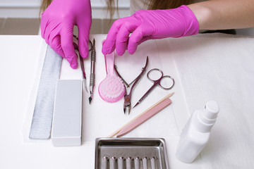 Workplace with manicure professional tools on white background. Nailcare instrument in beautician's...