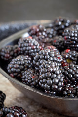 Closeup of freshly harvested ripe blackberries in bowl