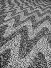 Portuguese pavement (calcada portuguesa) with wave patterns in black and white