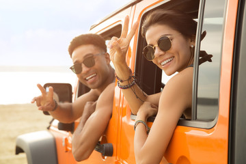 Smiling multiethnic couple sitting in a car