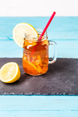 Iced tea in a glass jar with lemon.