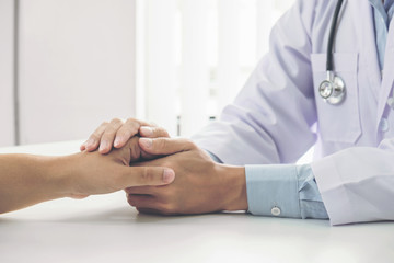 Close up of doctor touching patient hand for encouragement and empathy on the hospital, cheering and support patient, Bad news, medical examination, trust and ethics - obrazy, fototapety, plakaty