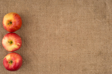 Red apple on sackcloth.