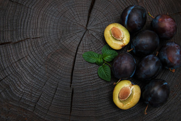 Fresh plums with green leaves