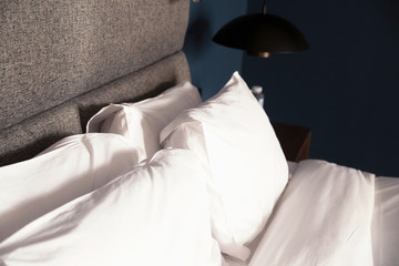 bed with a pillow,table, lamp
