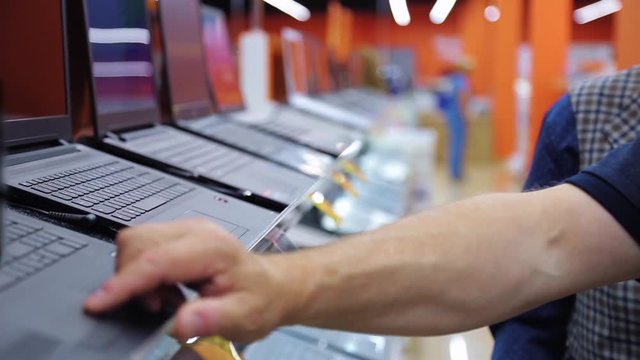 buyers choose a laptop in the store
