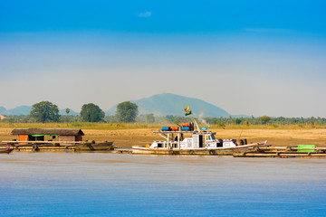 Boats near the bank of the river Irravarddy, Mandalay, Myanmar, Burma. Copy space for text.