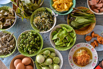 Fototapeta na wymiar Variety of local vegetables having with curry rice noodle (Thai Southern style)