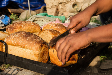 Baker cuts fresh bread
