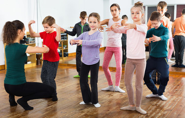 Fototapeta premium Young ballet dancers exercising in ballroom
