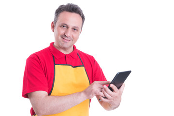 Smiling male staff using digital tablet in supermarket