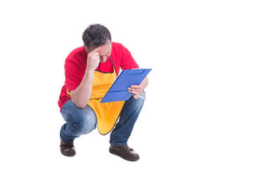 Tired male seller doing inventory