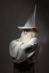 A man in a sorcerer costume on a black background