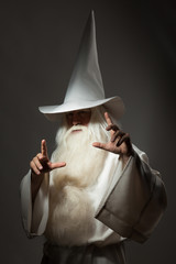 A man in a sorcerer costume on a black background