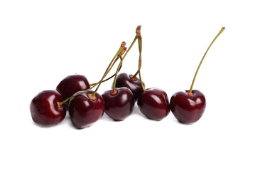 Ripe, washed appetizing and tasty bright red cherries on a white isolated background