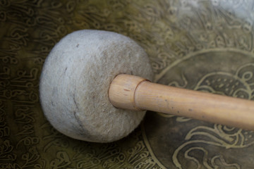 Tibetan singing bowls with a picture. Hammer for extracting sounds from the bowls
