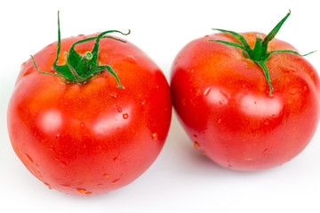 Two fresh tomatoes with water drops