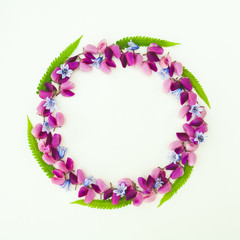 Flowers composition. Wreath made of various colorful flowers on white background. Easter, spring, summer, minimal concept. Flat lay, top view