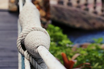 Adventure wooden rope suspension bridge closeup