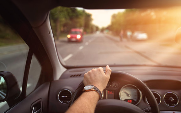 Sunny Day Behind The Steering Wheel Of The Car