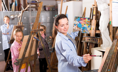 Obraz na płótnie Canvas Students practicing their skills during painting class