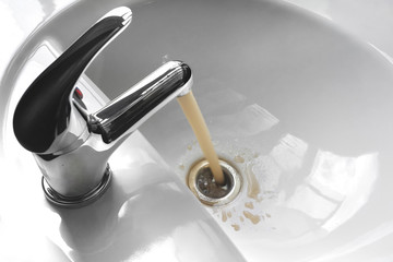 Water Tap With Running Dirty Muddy Water in a Sink - obrazy, fototapety, plakaty