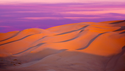Beautiful sunset over sand dunes abstract background. Sahara desert in Morocco, Africa
