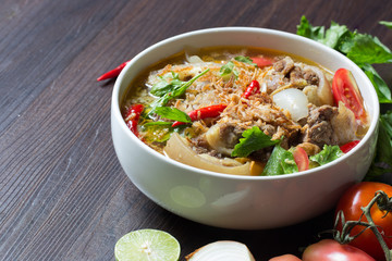 Oxtail soup, halal food, delicious, Muslim food in white bowl on dark brown wooden plate / Selective focus