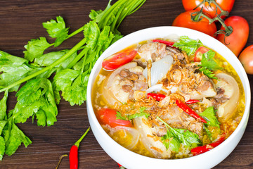 Oxtail soup, halal food, delicious, Muslim food in white bowl on dark brown wooden plate / Selective focus