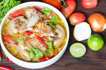 Oxtail soup, halal food, delicious, Muslim food in white bowl on dark brown wooden plate / Selective focus