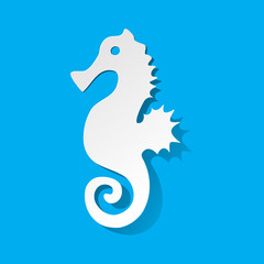 Seahorse cut out of paper white on a blue background.