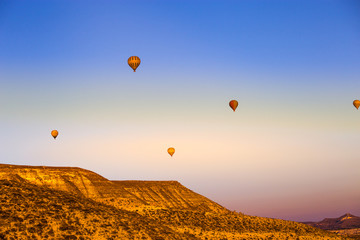 Colorful hot air balloons flying over the valley at Cappadocia,Anatolia,Turkey.The great tourist attraction of Cappadocia best places to fly with hot air balloons.NEVSEHIR/TURKEY- JULY 23,2016