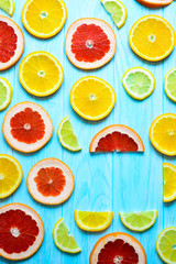 Citrus fruits on blue wooden background.