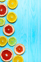 Fototapeta na wymiar Citrus fruits on blue wooden background.