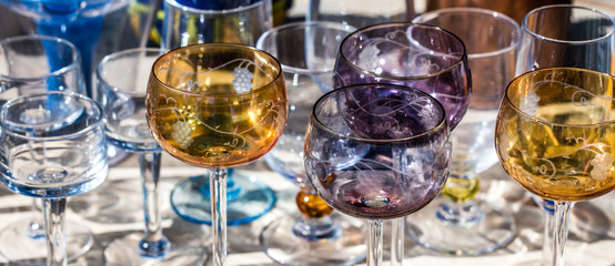 beautiful French wine glasses in different colors, panoramic view