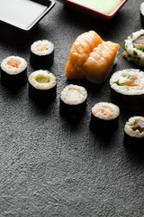 Sushi set on black table background