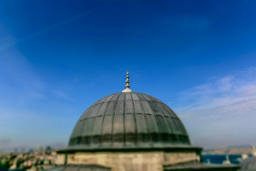 Fototapeta na wymiar ISTANBUL,TURKEY-MAY 01,2017:View of galata tower from courtyard of Suleymaniye Mosque through domes of madrasas, Istanbul, Turkey